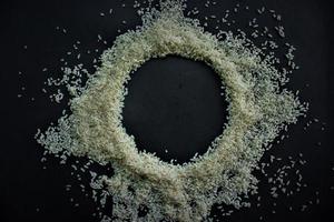 Raw rice from Indonesia with look circle shape in the center isolated on black background photo