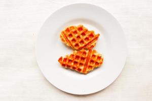 Croissant Waffle or Croffle with chocolate sauce served in box and white background photo