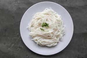 bihun or vermicelli or rice noodles or angel hair served on plate isolated on black background photo