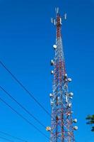 communication tower. Telco Trellis for 3G 4G 5G Apocalypse Internet Communication, mobile, FM Radio and Television Broadcasting On Air with Blue Sky in Background photo