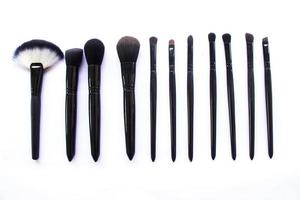 makeup brushes set isolated on white background. Top view, flat lay photo