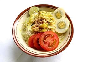 Soto Lamongan is a dish of Soup Lamongan, East Java, Indonesia. made of chicken, vermicelli, egg, bean sprout, turmeric, the broth and koya photo