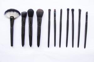 makeup brushes set isolated on white background. Top view, flat lay photo