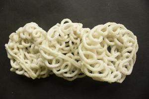 kerupuk or krupuk or crackers isolated on black background. kerupuk is snacks made from tapioca flour dough mixed with flavorings such as shrimp or fish. traditional snack from indonesia photo