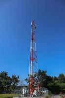 communication tower. Telco Trellis for 3G 4G 5G Apocalypse Internet Communication, mobile, FM Radio and Television Broadcasting On Air with Blue Sky in Background photo