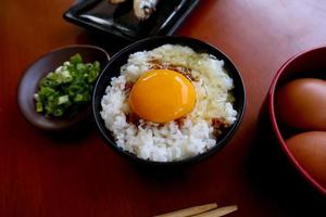 tamago kake gohan or raw egg on rice. traditional food from japan, eat on breakfast photo