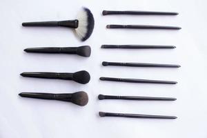 makeup brushes set isolated on white background. Top view, flat lay photo