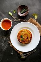 paratha bread or canai bread or roti maryam, favorite breakfast dish. served on plate photo