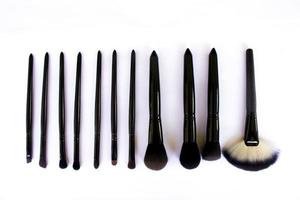 makeup brushes set isolated on white background. Top view, flat lay photo