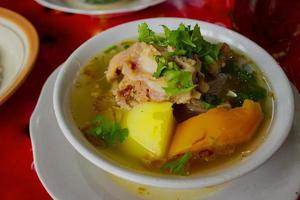 sop buntut or oxtail soup or tail soup is traditional soup made from tail ox, Boiled with Spices photo