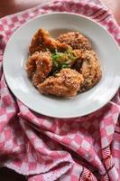 Delicious homemade crispy fried chicken with spicy taste and lemon on plate photo