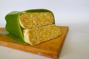 Raw tempeh or tempe. tempeh slices in white background. raw soybean seeds. Tempe is a traditional Indonesian food made from fermented soybeans. photo