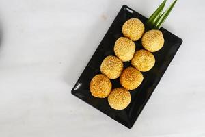 onde-onde or sesame ball or Jian Dui is fried Chinese pastry made from glutinous rice flour and coated with sesame seeds filled with bean paste. isolated on white background photo