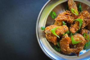 Delicious homemade crispy fried chicken with spicy taste and lemon on plate photo