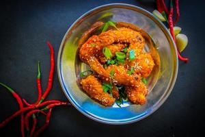 Delicious homemade crispy fried chicken with spicy taste and lemon on plate photo