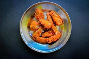 Delicious homemade crispy fried chicken with spicy taste and lemon on plate photo