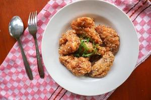 Delicious homemade crispy fried chicken with spicy taste and lemon on plate photo