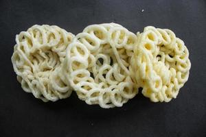 kerupuk or krupuk or crackers isolated on black background. kerupuk is snacks made from tapioca flour dough mixed with flavorings such as shrimp or fish. traditional snack from indonesia photo