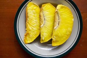 sukun goreng or fried breadfruit served at plate on black background photo