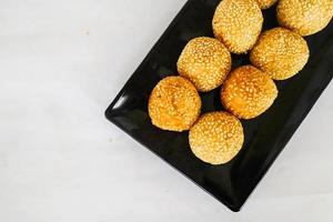 onde-onde or sesame ball or Jian Dui is fried Chinese pastry made from glutinous rice flour and coated with sesame seeds filled with bean paste. isolated on white background photo