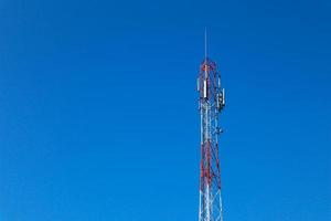 communication tower. Telco Trellis for 3G 4G 5G Apocalypse Internet Communication, mobile, FM Radio and Television Broadcasting On Air with Blue Sky in Background photo