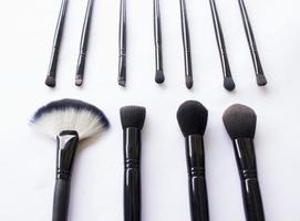 makeup brushes set isolated on white background. Top view, flat lay photo