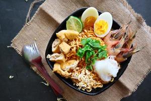 laksa, laksa curry made from vermicelli, noodles, bean sprouts, egg, tofu lime, and shrimp with a spicy soup sauce that is rich in spices. laksa served on bowl, isolated on white background. photo