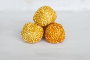 onde-onde or sesame ball or Jian Dui is fried Chinese pastry made from glutinous rice flour and coated with sesame seeds filled with bean paste. isolated on white background photo