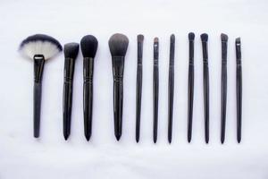 makeup brushes set isolated on white background. Top view, flat lay photo