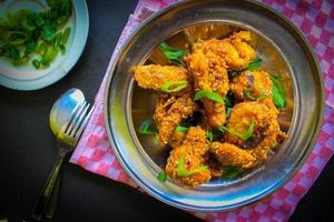 Delicious homemade crispy fried chicken with spicy taste and lemon on plate photo