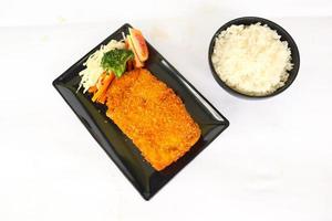 chicken katsu don is japanese food served with soy sauce on table photo