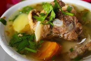 sop buntut or oxtail soup or tail soup is traditional soup made from tail ox, Boiled with Spices photo