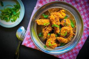 Delicious homemade crispy fried chicken with spicy taste and lemon on plate photo