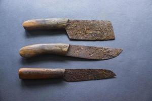 Rusty meat knife isolated on stone backgroundRusty meat knife isolated on stone background photo