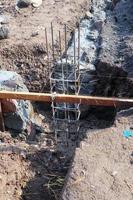 The foundation for the house. Laying the foundation made from stone, sand, semen and steel. Construction works. photo