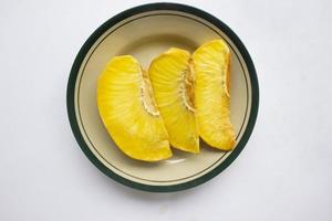 sukun goreng or fried breadfruit served at plate on black background photo