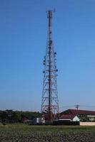 communication tower. Telco Trellis for 3G 4G 5G Apocalypse Internet Communication, mobile, FM Radio and Television Broadcasting On Air with Blue Sky in Background photo