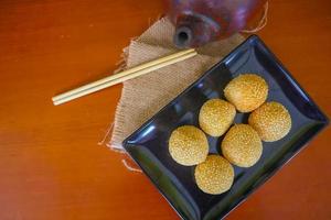 onde-onde or sesame ball or Jian Dui is fried Chinese pastry made from glutinous rice flour and coated with sesame seeds filled with bean paste. isolated on white background photo