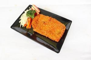 chicken katsu don is japanese food served with soy sauce on table photo