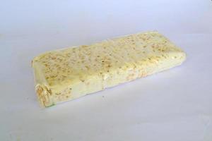 Raw tempeh or tempe. tempeh slices in white background. raw soybean seeds. Tempe is a traditional Indonesian food made from fermented soybeans. photo