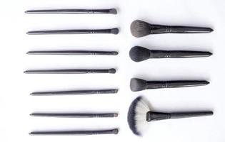 makeup brushes set isolated on white background. Top view, flat lay photo