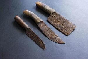 Rusty meat knife isolated on stone backgroundRusty meat knife isolated on stone background photo