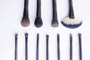 makeup brushes set isolated on white background. Top view, flat lay photo