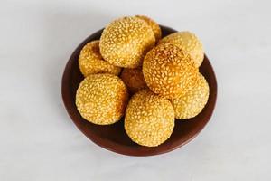 onde-onde or sesame ball or Jian Dui is fried Chinese pastry made from glutinous rice flour and coated with sesame seeds filled with bean paste. isolated on white background photo