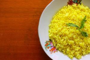 yellow rice or turmeric rice or nasi kuning is food made from rice cooked with turmeric, coconut milk and spices. so the taste is more savory photo
