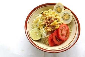 Soto Lamongan is a dish of Soup Lamongan, East Java, Indonesia. made of chicken, vermicelli, egg, bean sprout, turmeric, the broth and koya photo