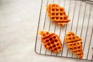 gofre croissant o croffle con salsa de chocolate servido en caja y fondo blanco foto