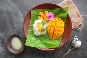 mango sticky rice is Thai dessert made of sticky rice, mango and coconut milk. photo