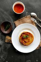 paratha bread or canai bread or roti maryam, favorite breakfast dish. served on plate photo