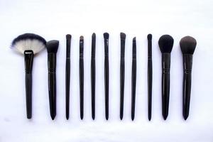 makeup brushes set isolated on white background. Top view, flat lay photo